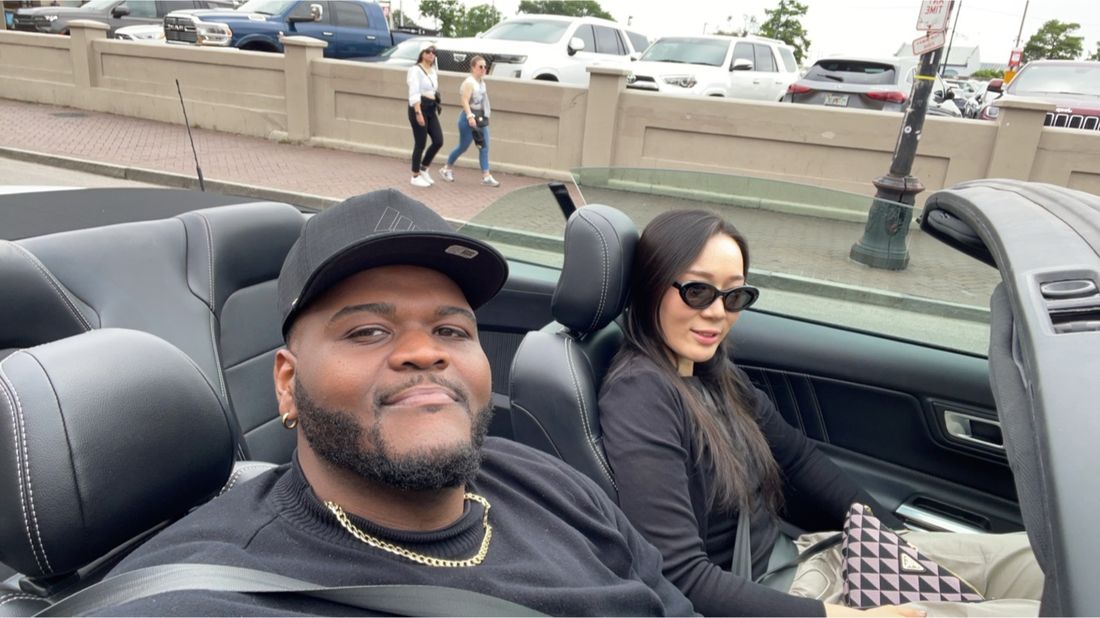 Tam and a friend on a road trip in a convertible