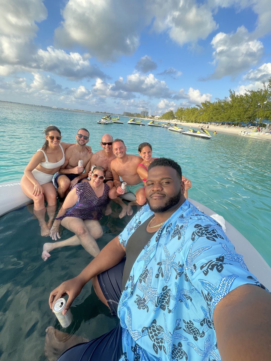 Tam and friends relaxing on a floating platform in turquoise water