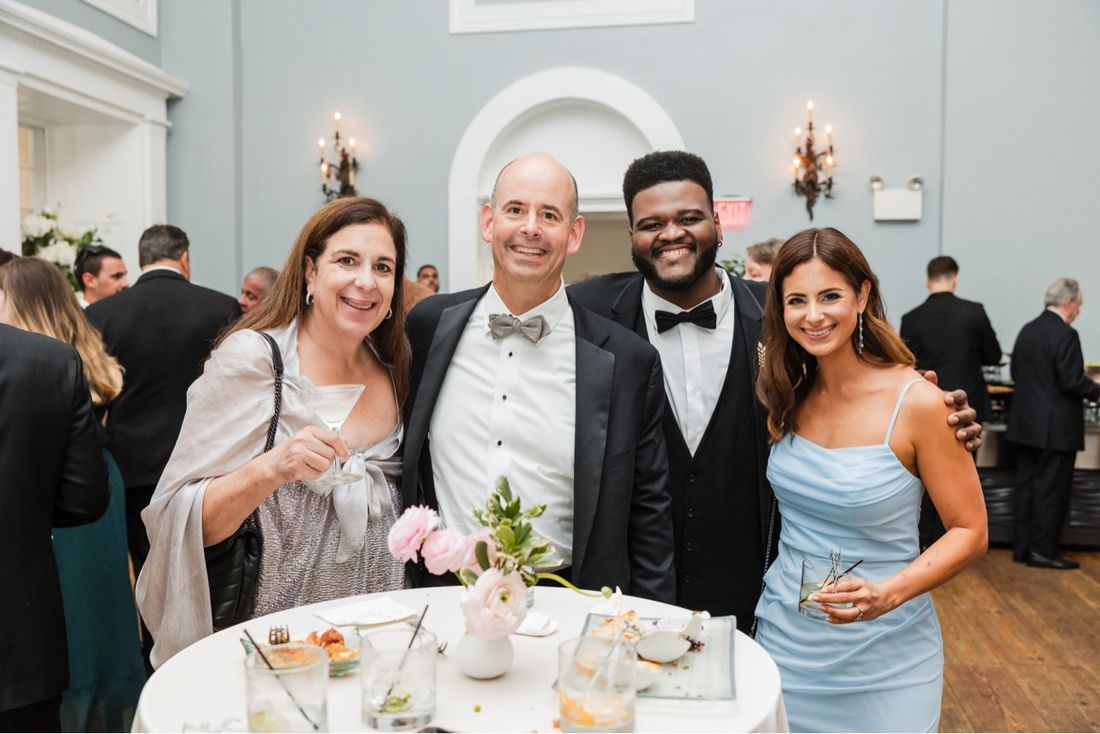 Tam in a bow tie with friends at a formal celebration